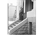 Photo of Mary McLeod Bethune standing on steps, front entrance to house, ca. 1950.