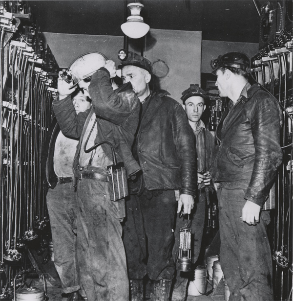 Image of Miners wearing helemts with Edison Cap Lamps