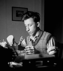 A photograph of young Ralph Baer working with electronics