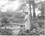 Photo of Dr. Anna J. Cooper in her garden, home & patio, ca. 1940?