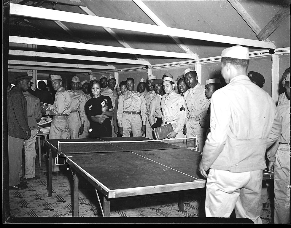 Young man and woman playing table tennis, 1940-1950