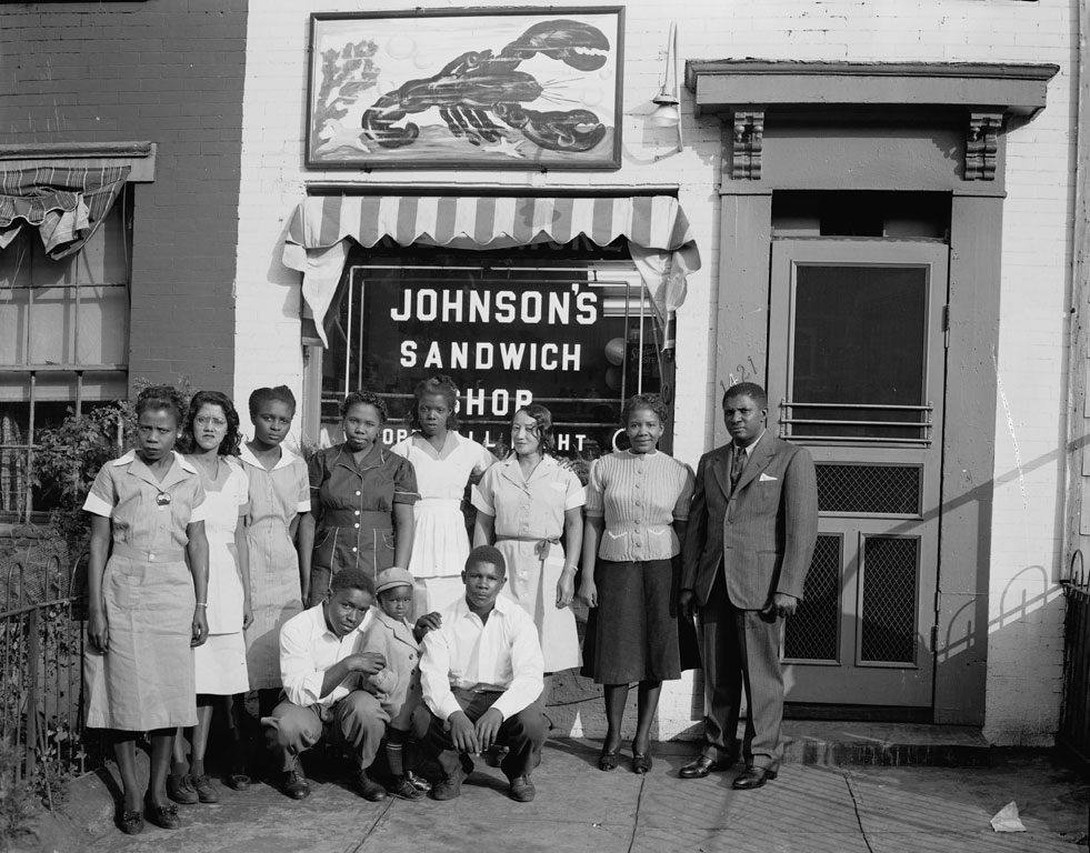 Photo of group in front of Johnson's Sandwich Shop, ca. 1950.