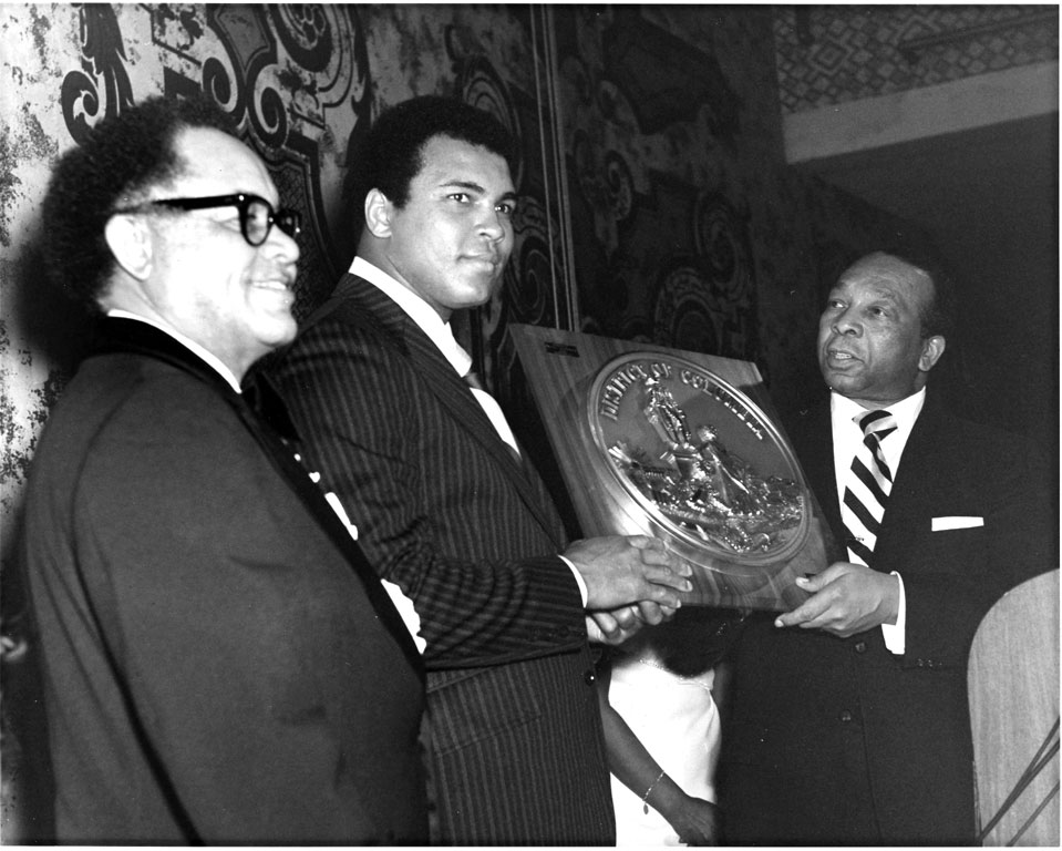 Photo of Muhammed Ali with Mayor Walter Washington, receiving award, ca 1970