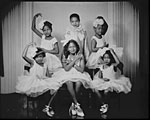 Photo of Five African American girls wearing ballet costumes and shoes, ca. 1948