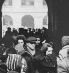 A group of Dutch Jews just arrived in Theresienstadt being herded through a stone archway into the camp (no date).  Courtesy of United States Holocaust Memorial Museum
